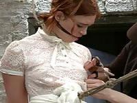 Bound redhead zappered on hogtie
